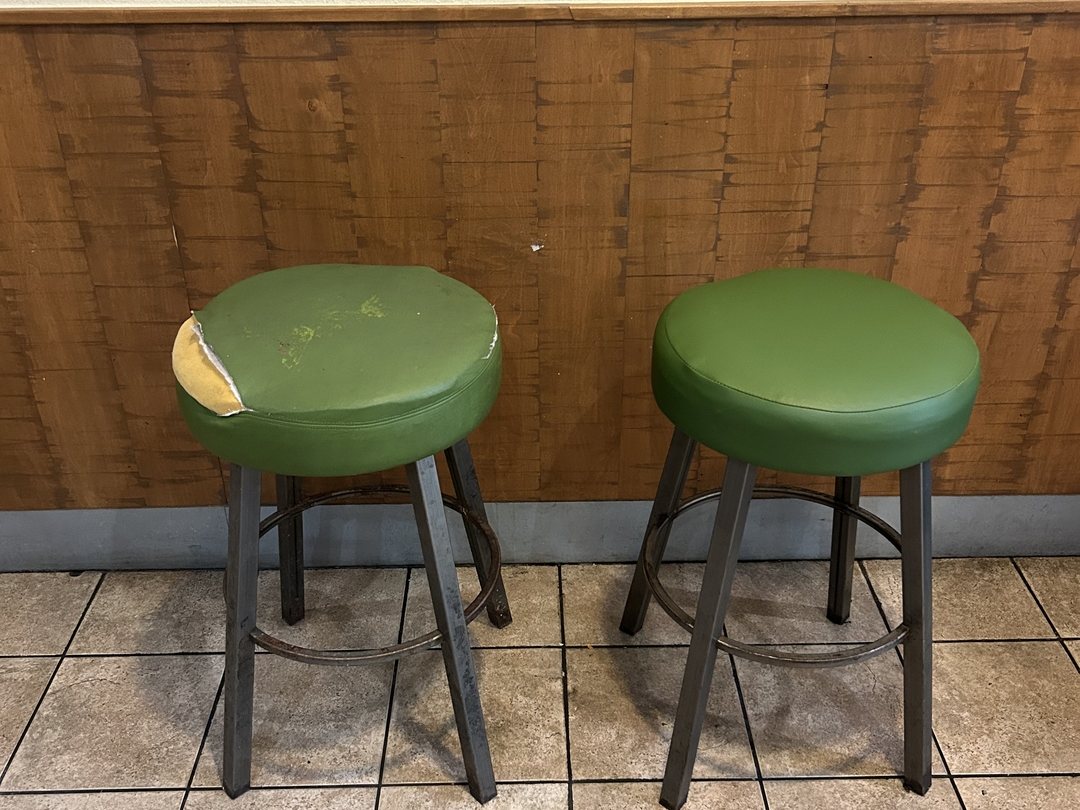 Before and after San Diego bar stool reupholstery: torn green vinyl seat with exposed foam beside the finished reupholstered stool